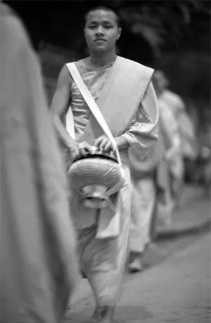 Buddhist monk walking to do morning alms