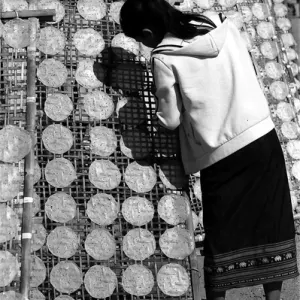 Girl drying rice cakes