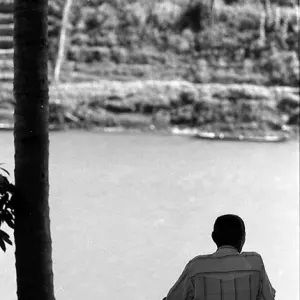 Man looking at Nam Khan river