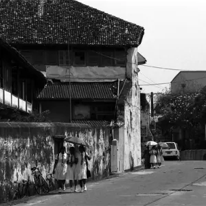Schoolgirls walking street in old city