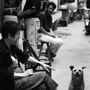 People and dog relaxing in lane