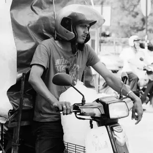 Men carrying big burden with motorbike