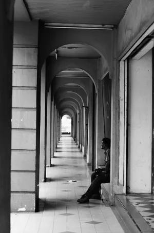 Man sitting alone in deserted passage