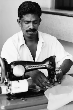Man working with an old sewing machine
