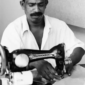 Man working with an old sewing machine