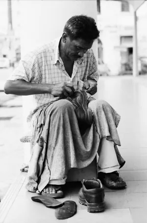 Shoemaker working by roadside