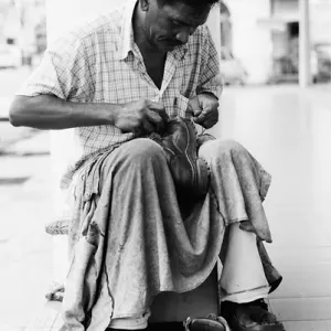Shoemaker working by roadside