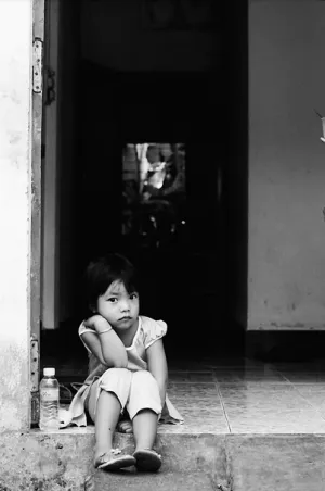 Little girl sitting at entrance