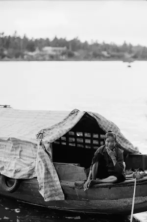 Older woman sitting on moored boat