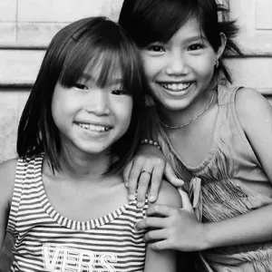 Two girls smiling together