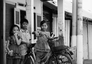 Three kids and one bicycle