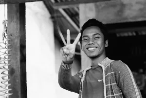 Young man replying with peace sign