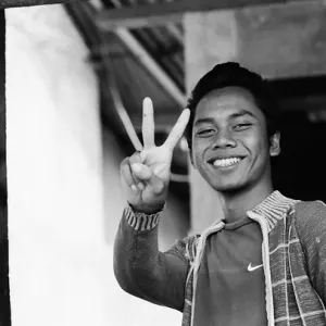 Young man replying with peace sign
