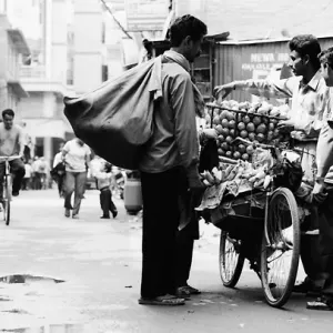 Man buying mangoes from fruit seller