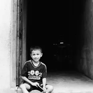 Boy sitting at entrance