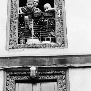 Mother and sons ralaxing by window