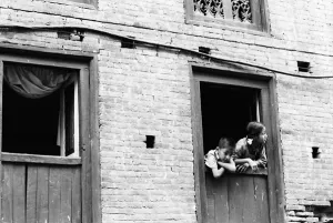 Boy and girl leaning out of window