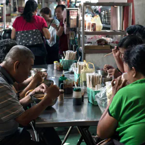 People eating in a food stall
