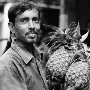 Man having two pineapples