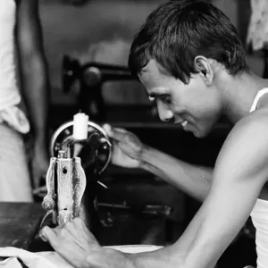 Man manipulating sewing machine