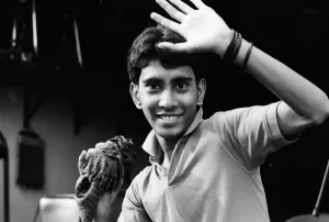Young man raising hand