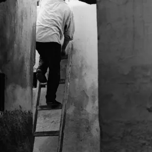 Man standing on ladder