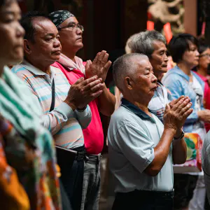 people joining hands in prayer