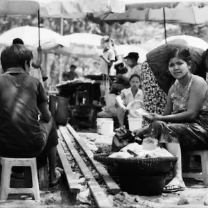 Woman sitting among stalls