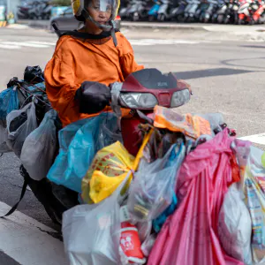 Motorbike with many plastic bag