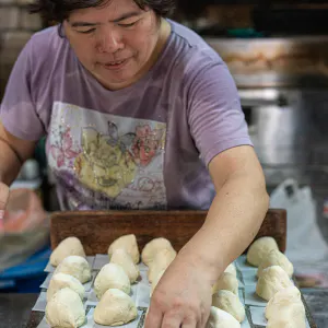 Woman setting out meat buns