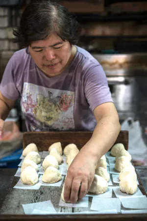 Woman setting out meat buns