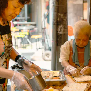 Women making sushi rolls