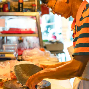 Fishmonger holding unusual type of kitchen knife