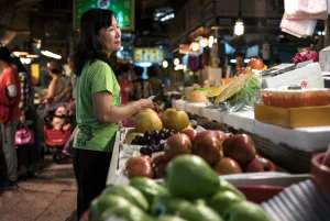 Smiling woman in fruit store