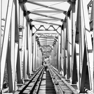 Figures crossing railway bridge