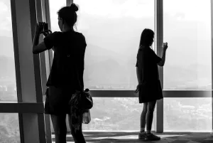 Two silhouetted women taking photos