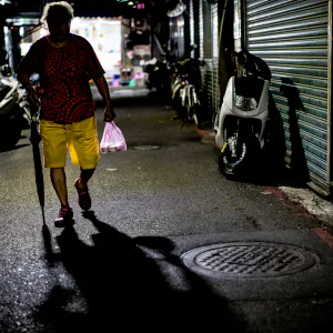 silhouette carried umbrella and plastic bag