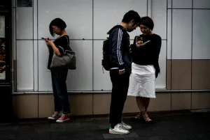 Persons watching smartphones