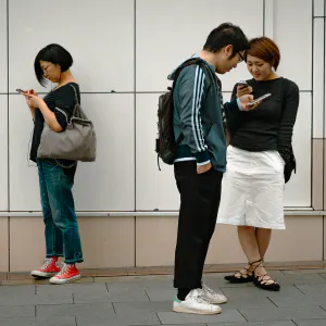 Persons watching smartphones