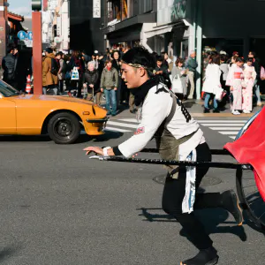 Rickshaw man and supercar