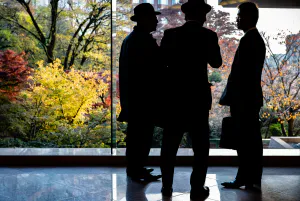 Three men by window