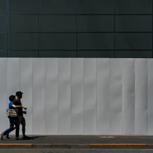 Couple in front of white fence