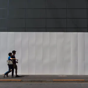 Couple in front of white fence