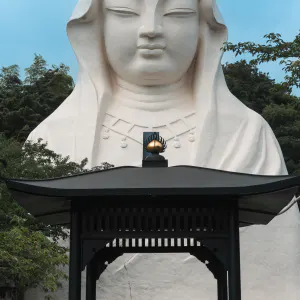 Woman praying in front of Guanyin