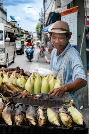 Man selling grilled bananas