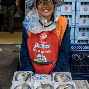 Woman selling packed fishes
