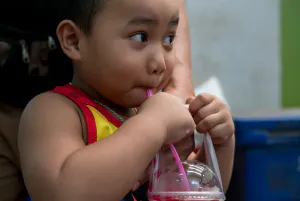 Boy drinking cold beverage