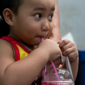 Boy drinking cold beverage