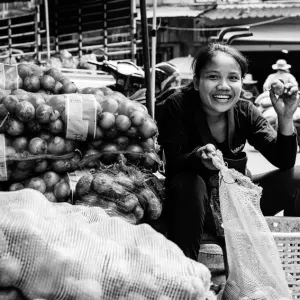 Young woman smiling with potato in hand