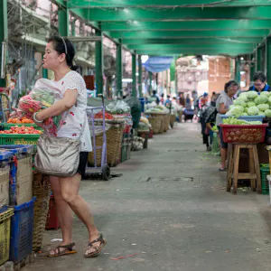 Woman standing in storefront of greengrocery